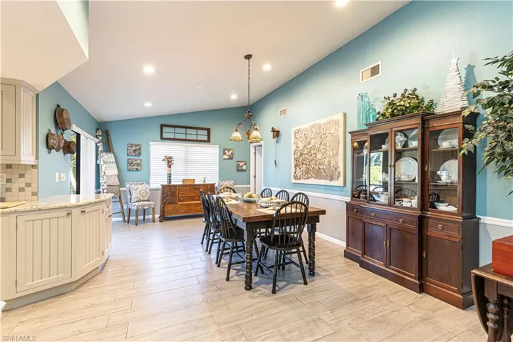 Dining space featuring light hardwood / wood-style floors and vaulted ceiling