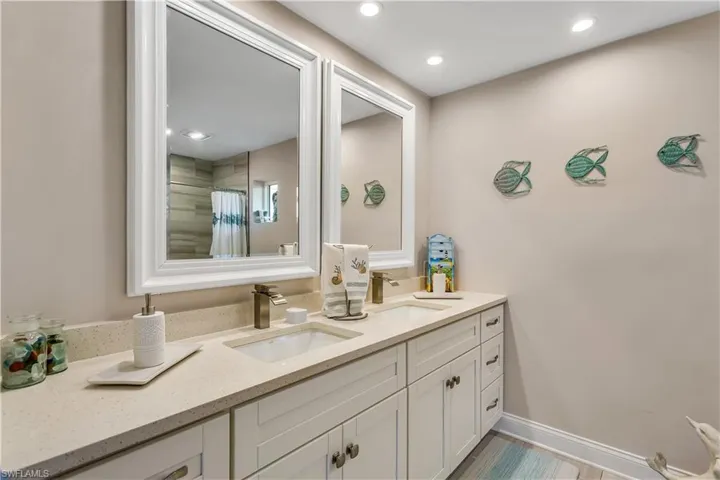 Bathroom featuring vanity and a shower
