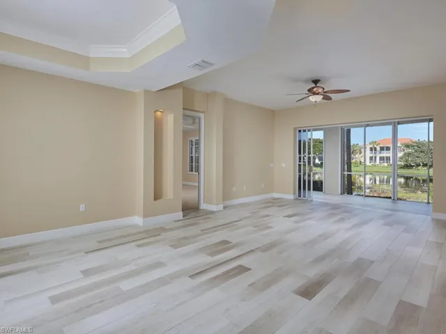 The primary living area is spacious and inviting with access to the enclose lanai.