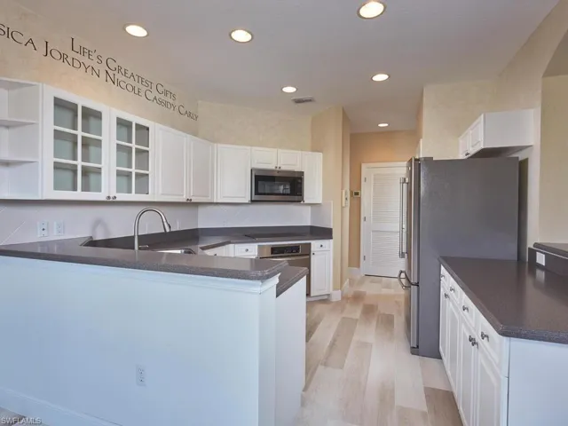 Imagine cooking a delicious meal for family or friends, utilizing stainless steel appliances and a plethora of storage and countertop space.