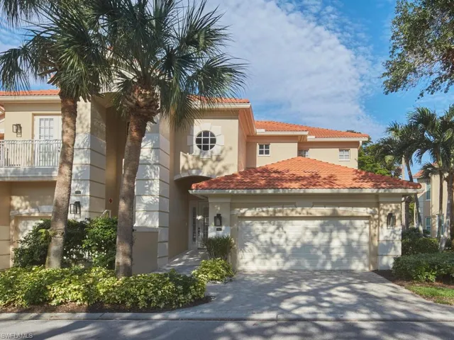 Enjoy the charming curb-appeal of this corner first floor unit with spacious 2 car garage