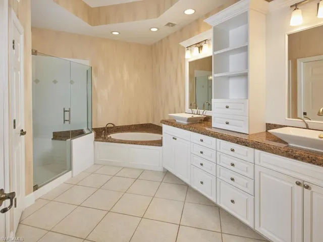 Large master bathroom with a double vanity, an upgraded shower, plenty of cabinet space and a relaxing bathtub.