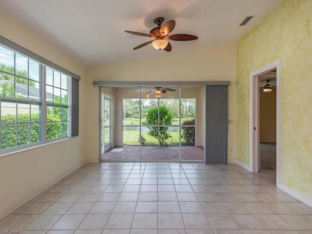Dining area & den featuring vaulted ceiling, light tile patterned floors, and ceiling fan