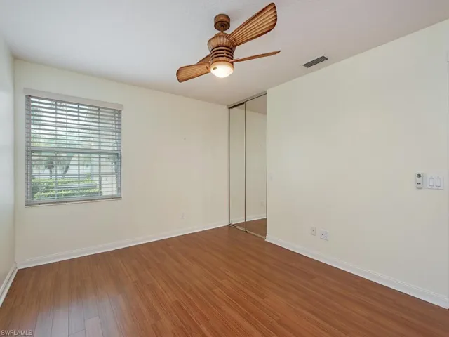 Guest room featuring wood finished floors and ceiling fan