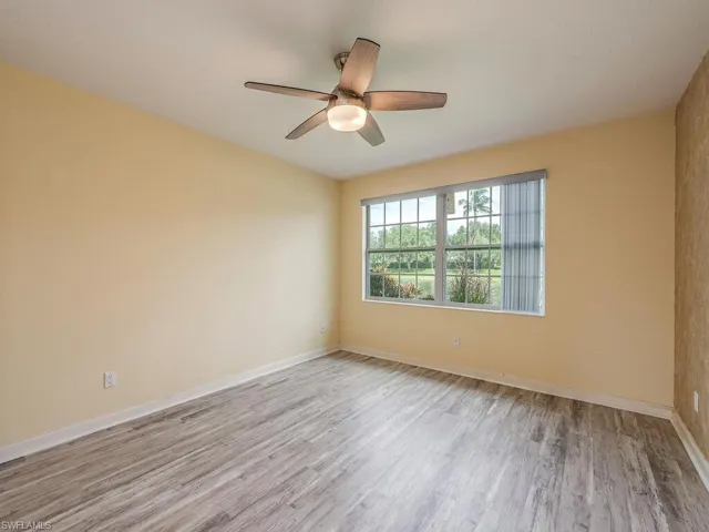 Guest room featuring light wood-type flooring and a ceiling fan