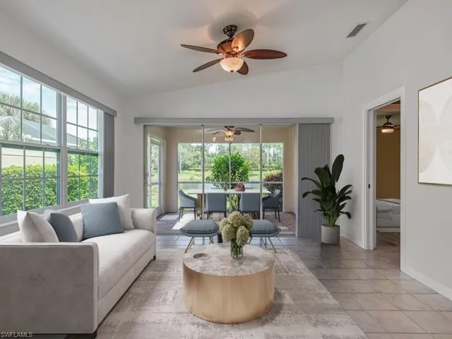 Virtual Staged Living room featuring vaulted ceiling, light tile patterned floors, and a ceiling fan