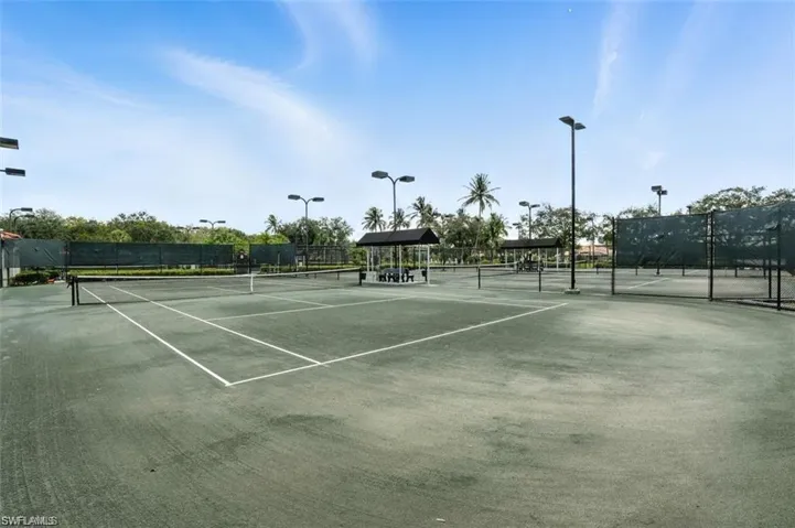 View of tennis court with a gazebo