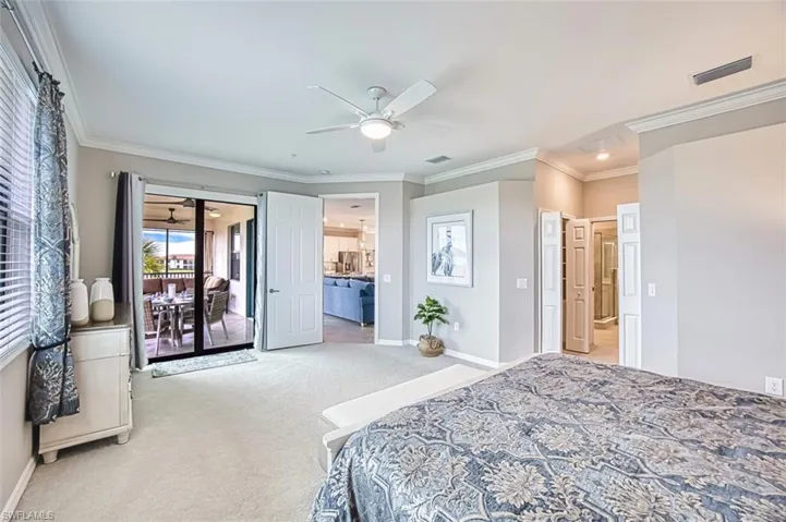 Bedroom with crown molding, access to lanai, light carpet, and ceiling fan