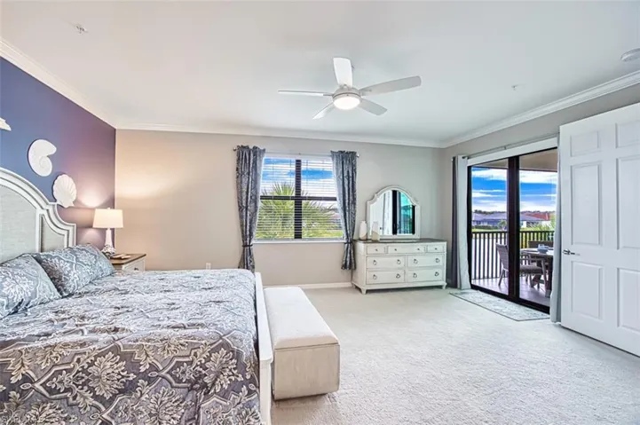Carpeted bedroom with ornamental molding, access to exterior, and a ceiling fan