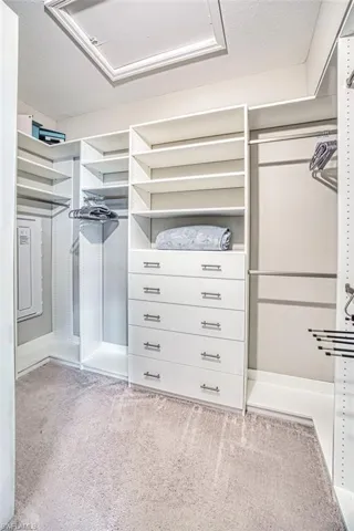 Walk in closet featuring Closet factory organization including hamper
