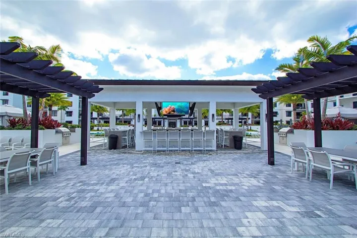 View of patio with a pergola, grilling area, exterior kitchen, and an outdoor bar