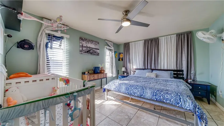 Bedroom featuring tile patterned flooring and a ceiling fan