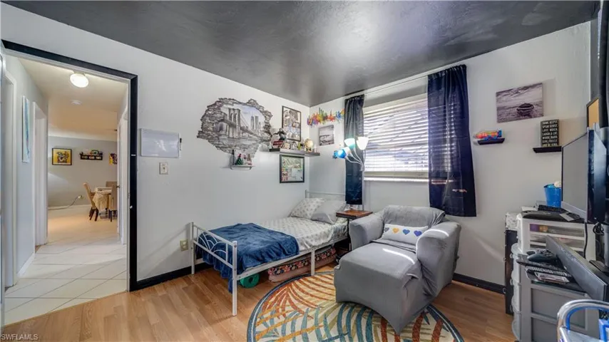 Bedroom with light wood-type flooring and baseboards