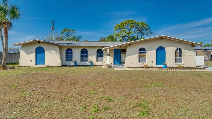Single story home featuring a front yard and stucco siding