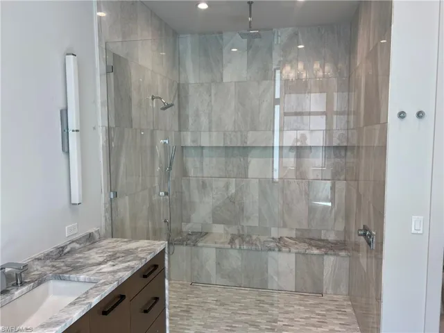 Full bathroom with walk in shower and vanity