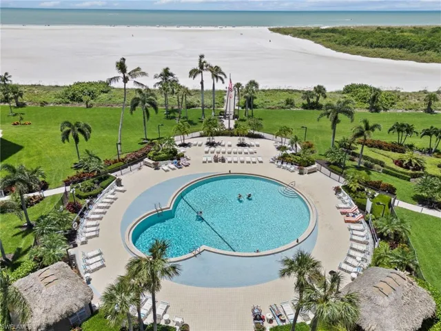 View of pool featuring a patio, a water view, and a lawn