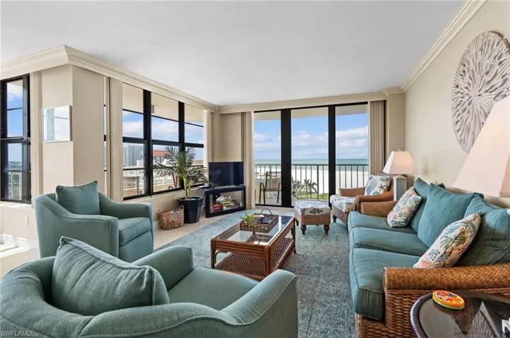 Living room with ornamental molding and carpet