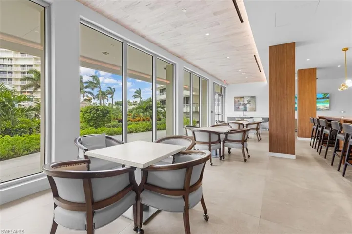 Dining area with light tile patterned floors and a healthy amount of sunlight