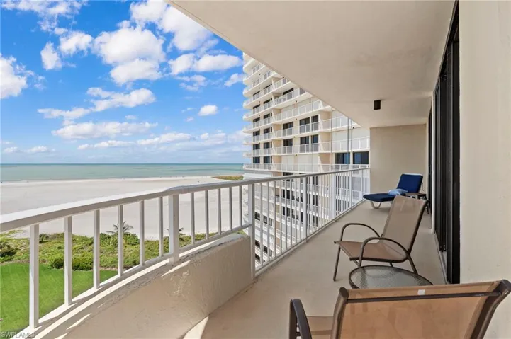 Balcony with a water view and a view of the beach
