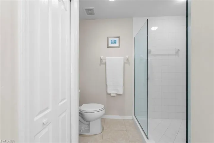 Master bath w/ large shower on right, linen closet to left