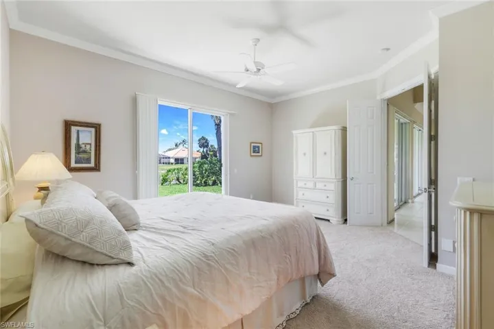 Bedroom featuring access to outside, crown molding, light colored carpet, and ceiling fan