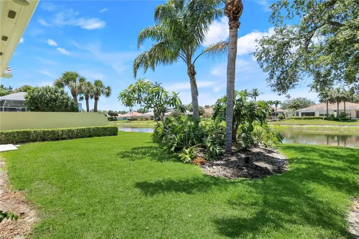 View of grassy yard with a water view and a residential view