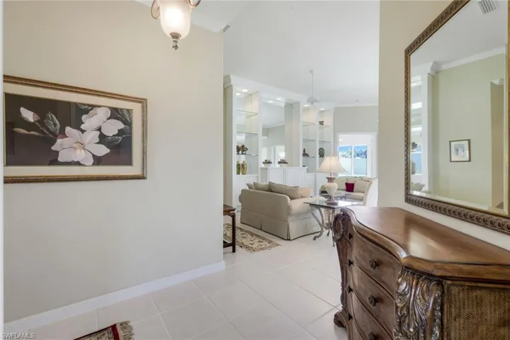 Hall featuring light tile patterned flooring and baseboards