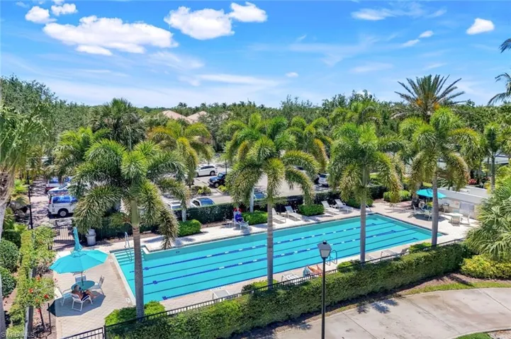 Community pool featuring fence and a patio