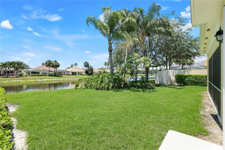 View of grassy yard featuring a water view and a residential view