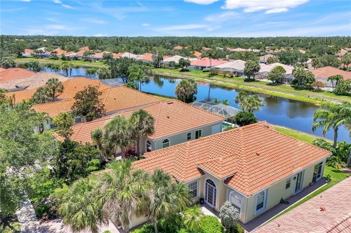 Aerial perspective of suburban area with a nearby body of water