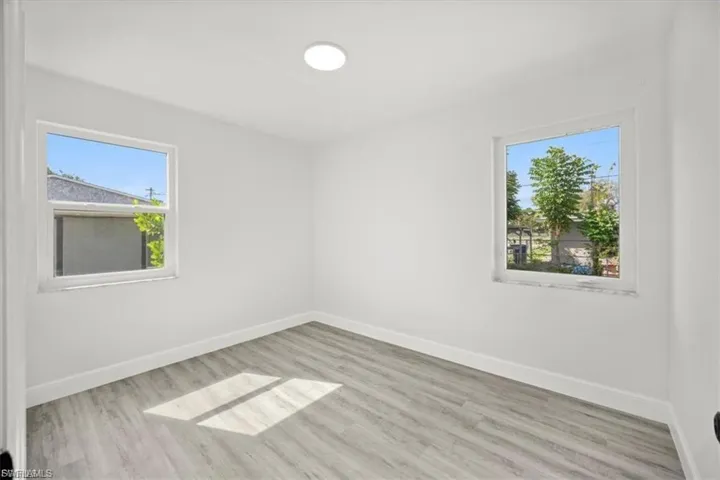 Spare room with light wood-style flooring and healthy amount of natural light