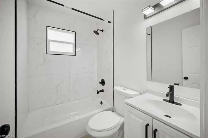 Bathroom with vanity and shower / bathtub combination