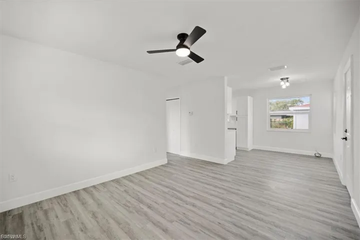 Unfurnished living room with light wood-style flooring and a ceiling fan