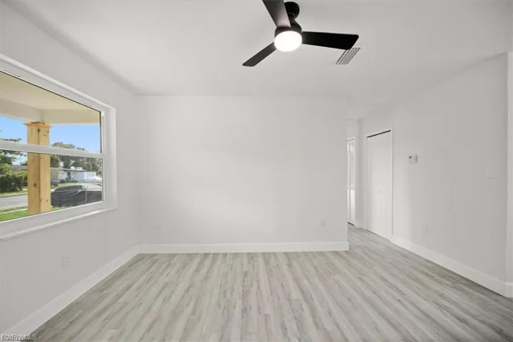 Unfurnished room with light wood finished floors and ceiling fan