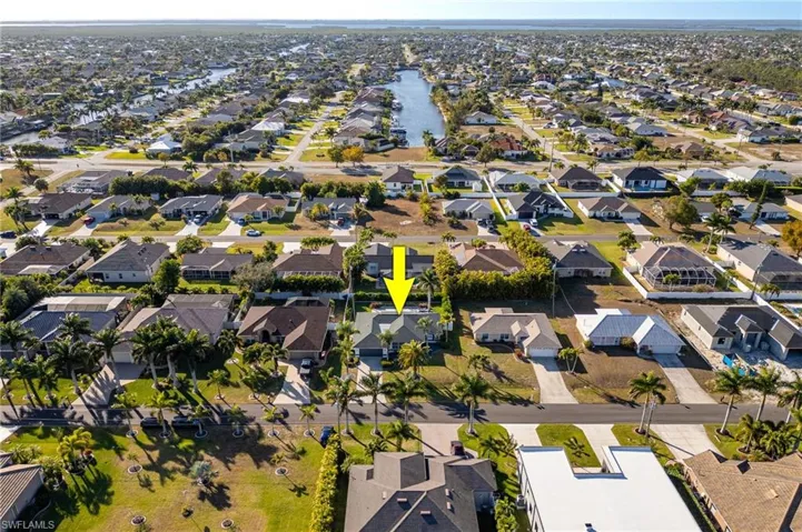 Aerial overview of property's location with nearby suburban area