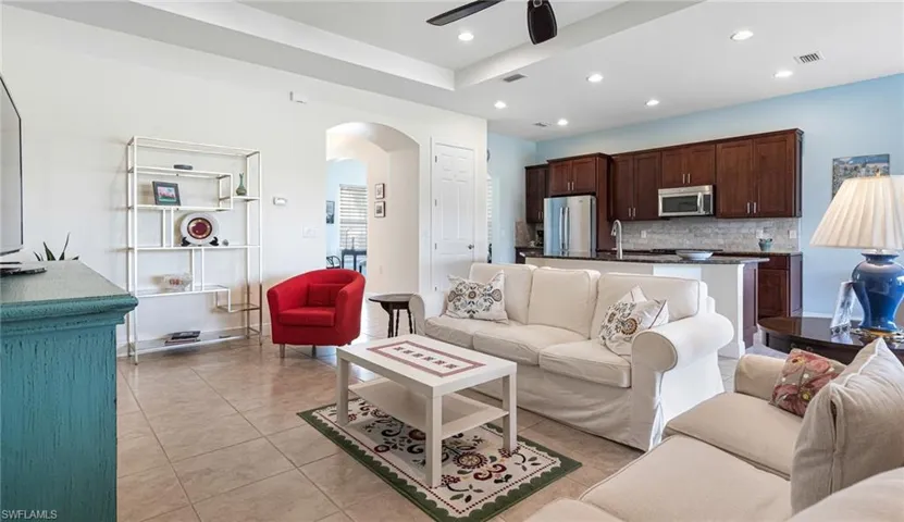 Great room with tray ceiling and tile floors