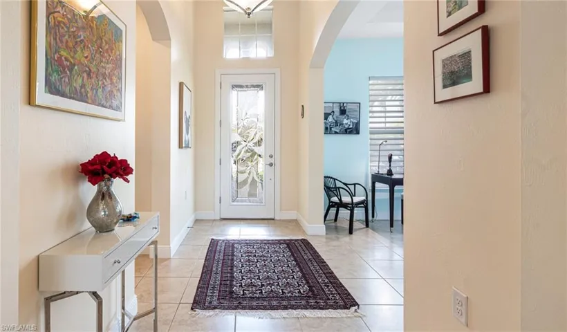 Entry with volume ceilings and glass door