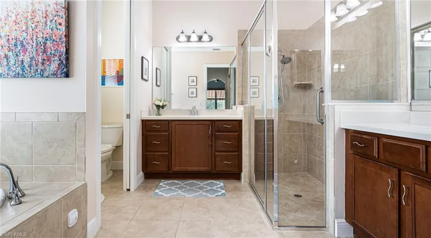 Master bath with separate sinks and tub