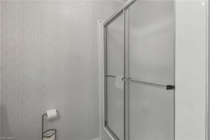 Full bathroom featuring a shower stall