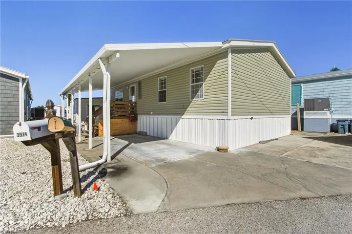 View of home's exterior with a carport and driveway