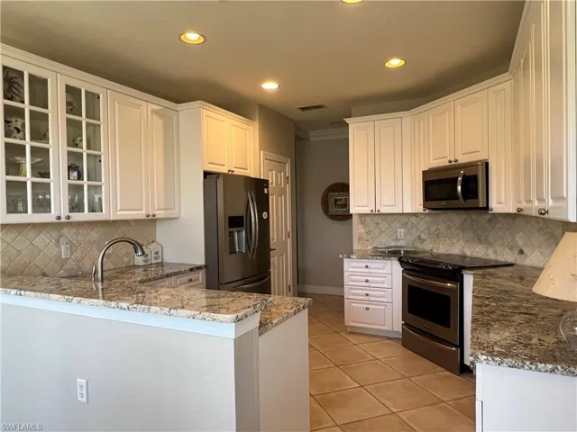 Remodeled kitchen with new countertops and custom cabinetry. Stainless steel appliances.