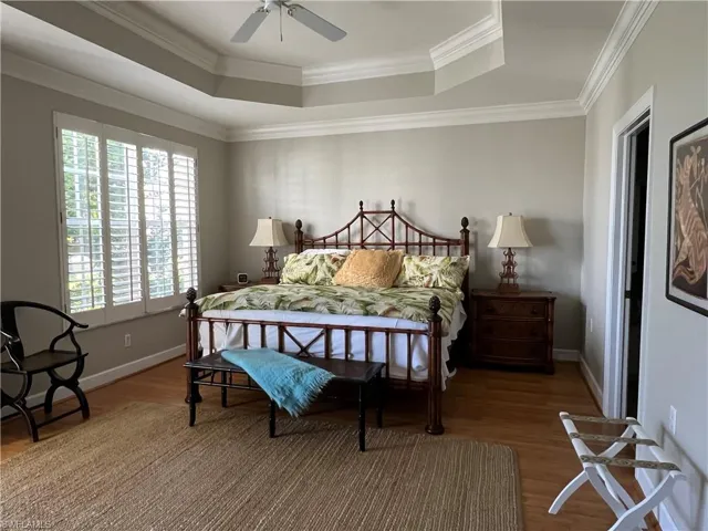 Master bedroom suite, upgraded Bamboo flooring, huge walk in closet to right, tray ceiling and slider door access to lanai on left.
