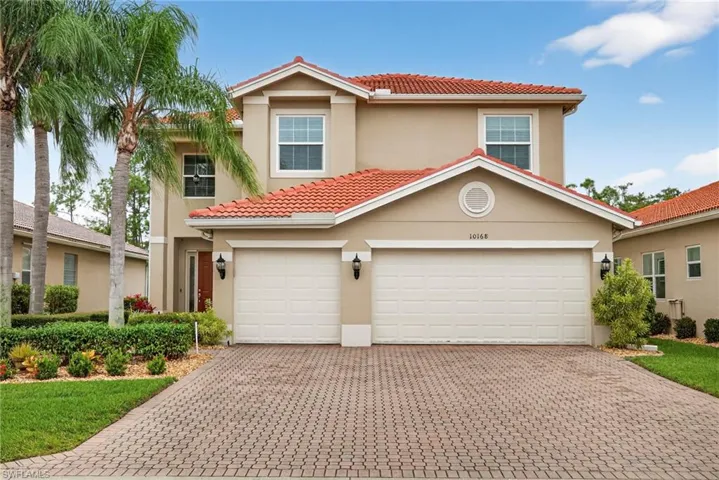 Mediterranean / spanish-style house with stucco siding, a tiled roof, decorative driveway, and a garage