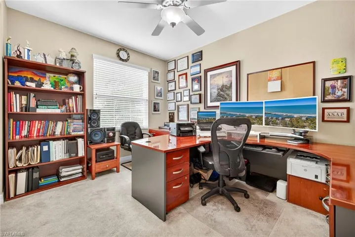 Home office featuring light carpet and ceiling fan
