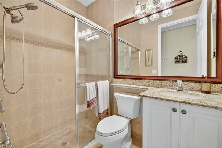 Bathroom with a stall shower and vanity