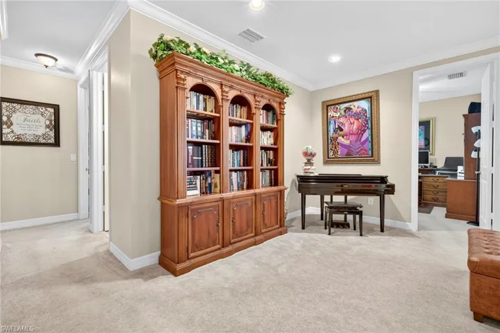 Sitting room featuring light carpet, ornamental molding, an office area, and recessed lighting