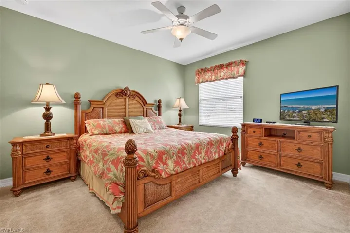Bedroom featuring light colored carpet and ceiling fan