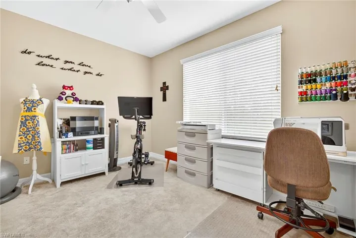 Office featuring light carpet and a ceiling fan