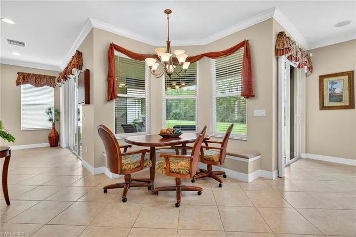 Dining area featuring crown molding, light tile patterned floors, a chandelier, and recessed lighting