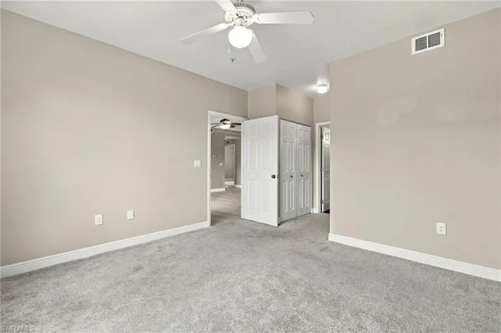 Neutral-toned walls complement the light gray carpeting